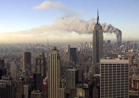 Distant photo of the World Trade Center towers burning after the September 